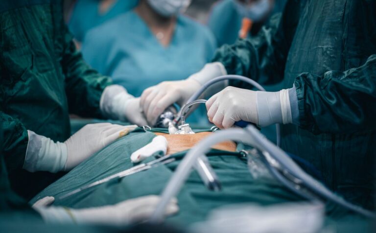 A detailed view of surgeons in action during an operation, highlighting surgical precision.